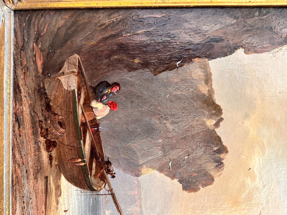 An early nineteenth-century oil painting depicting figures and boats along a rocky coastline, presented in an ornate swept giltwood frame. View III