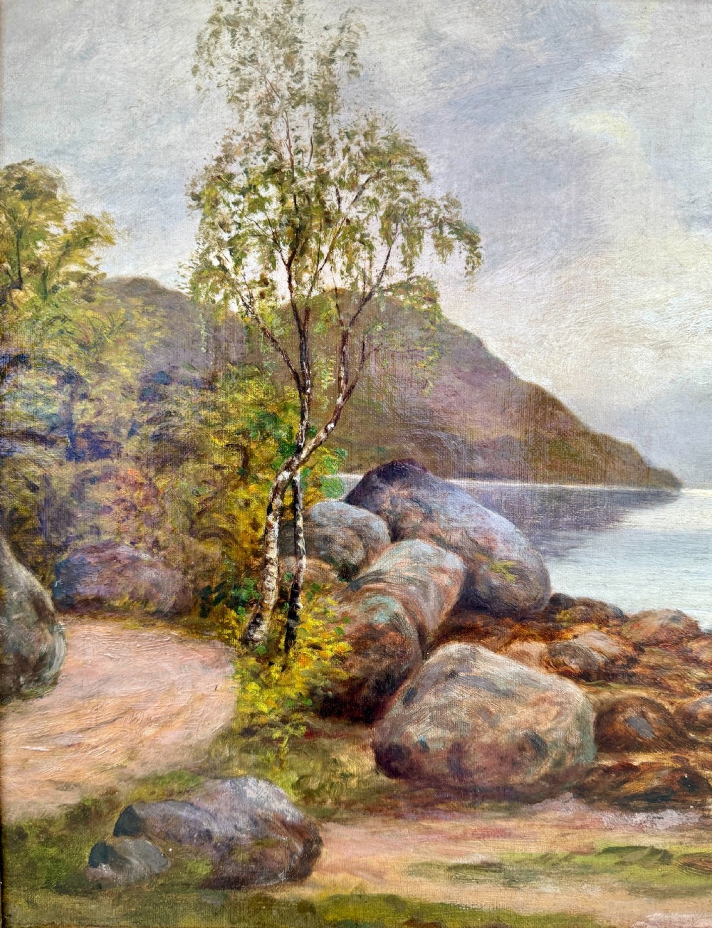 A Victorian oil painting depicting a calm Scottish loch with trees, rocky shorelines, and distant hills set inside a heavy moulded gilt wood frame. View III