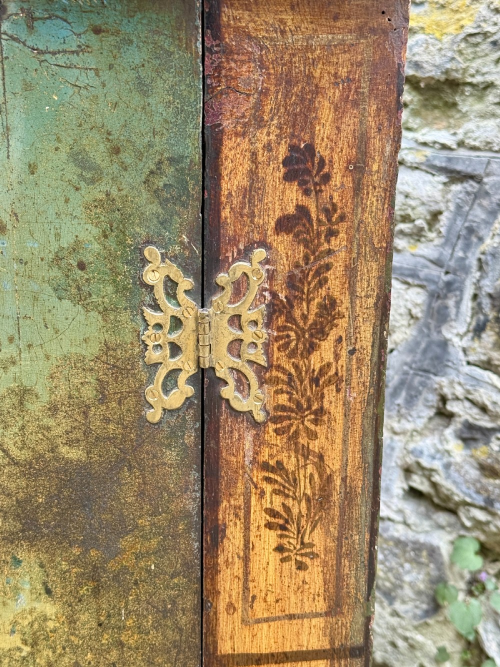 An eighteenth-century George II bowfront corner cupboard featuring two curved doors painted with a green pastoral scene and fitted with pierced brass hinges. View III