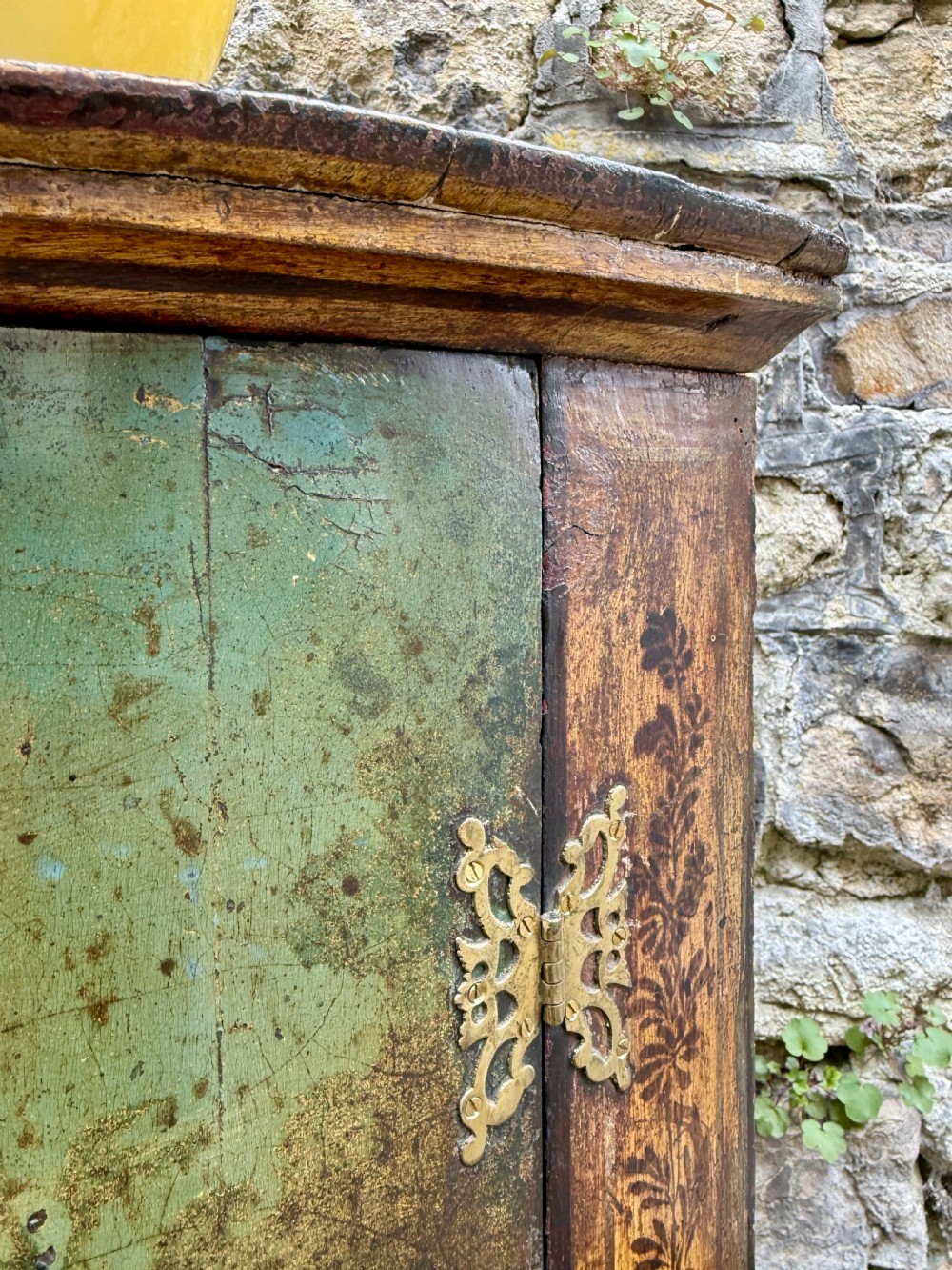 An eighteenth-century George II bowfront corner cupboard featuring two curved doors painted with a green pastoral scene and fitted with pierced brass hinges. View XI