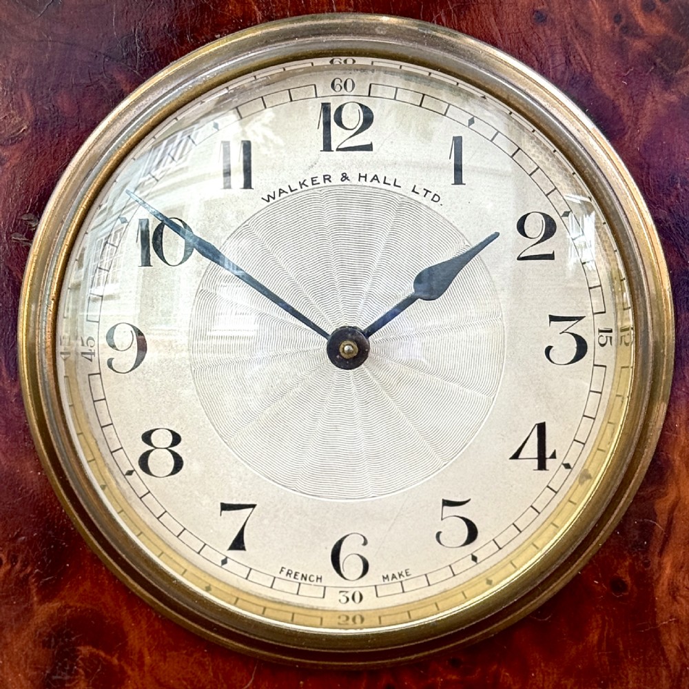 An early 20th-century rectangular mahogany and burr walnut mantel clock featuring ebonised side columns, a white circular dial signed Walker & Hall Ltd., and brass bracket feet. View II