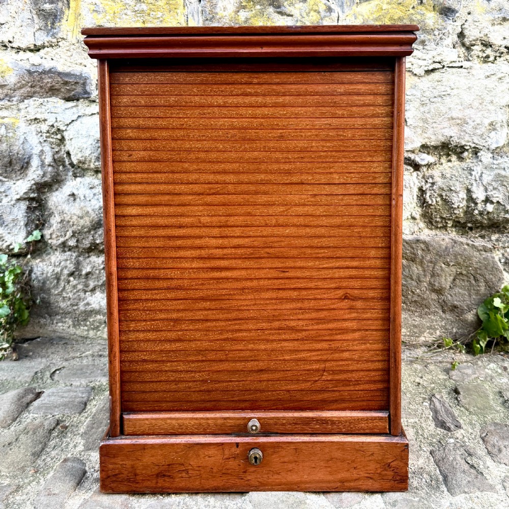 A late 19th-century rosewood filing cabinet featuring a slatted tambour shutter front and a lower drawer with brass keyhole escutcheons.