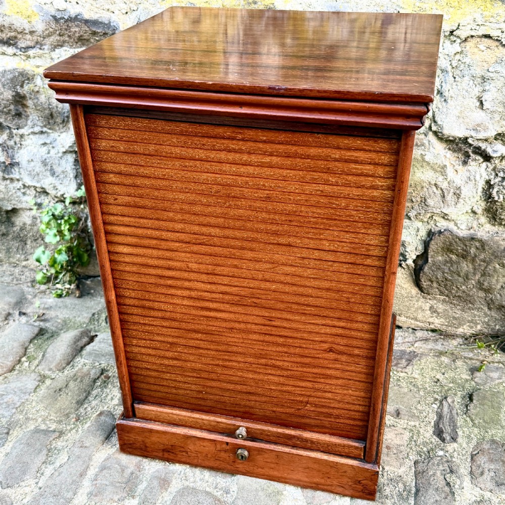 A late 19th-century rosewood filing cabinet featuring a slatted tambour shutter front and a lower drawer with brass keyhole escutcheons. View II