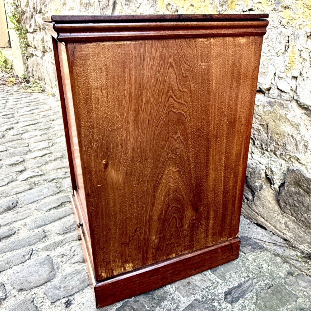 A late 19th-century rosewood filing cabinet featuring a slatted tambour shutter front and a lower drawer with brass keyhole escutcheons. View VII