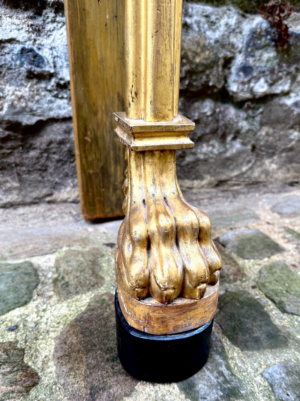 A Regency giltwood console table featuring a grey marble top supported by two carved lion monopodia front legs. View X
