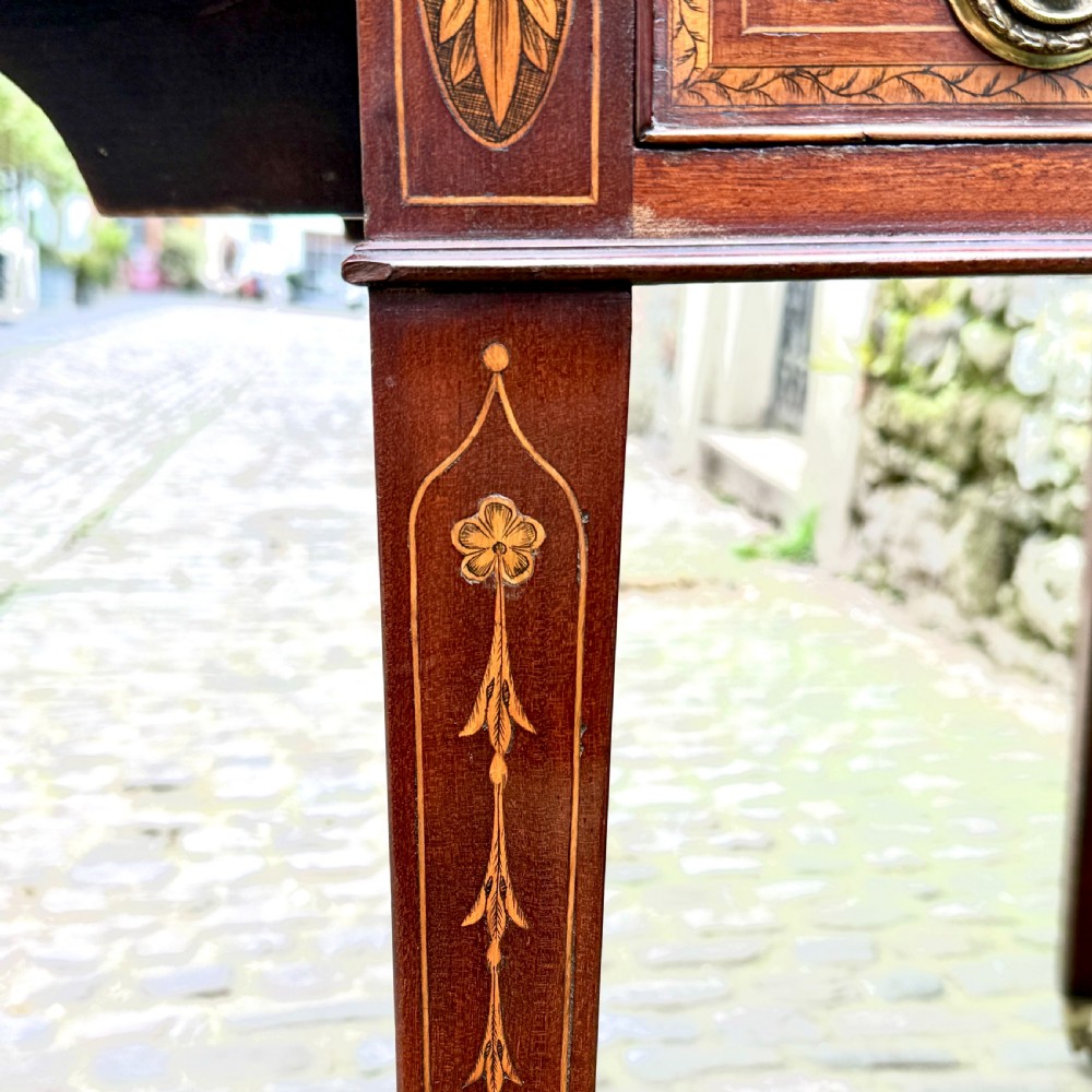 A George III mahogany Pembroke table with satinwood inlay, tapered square legs, and brass castors. View VIII