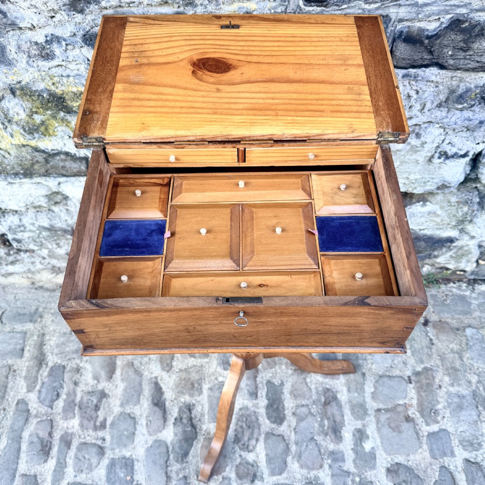 An early nineteenth-century French Provincial wooden chess table featuring an inlaid chessboard top, a turned pedestal support, and a tripod cabriole base. View VI