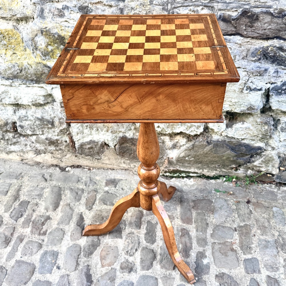 An early nineteenth-century French Provincial wooden chess table featuring an inlaid chessboard top, a turned pedestal support, and a tripod cabriole base. View VIII