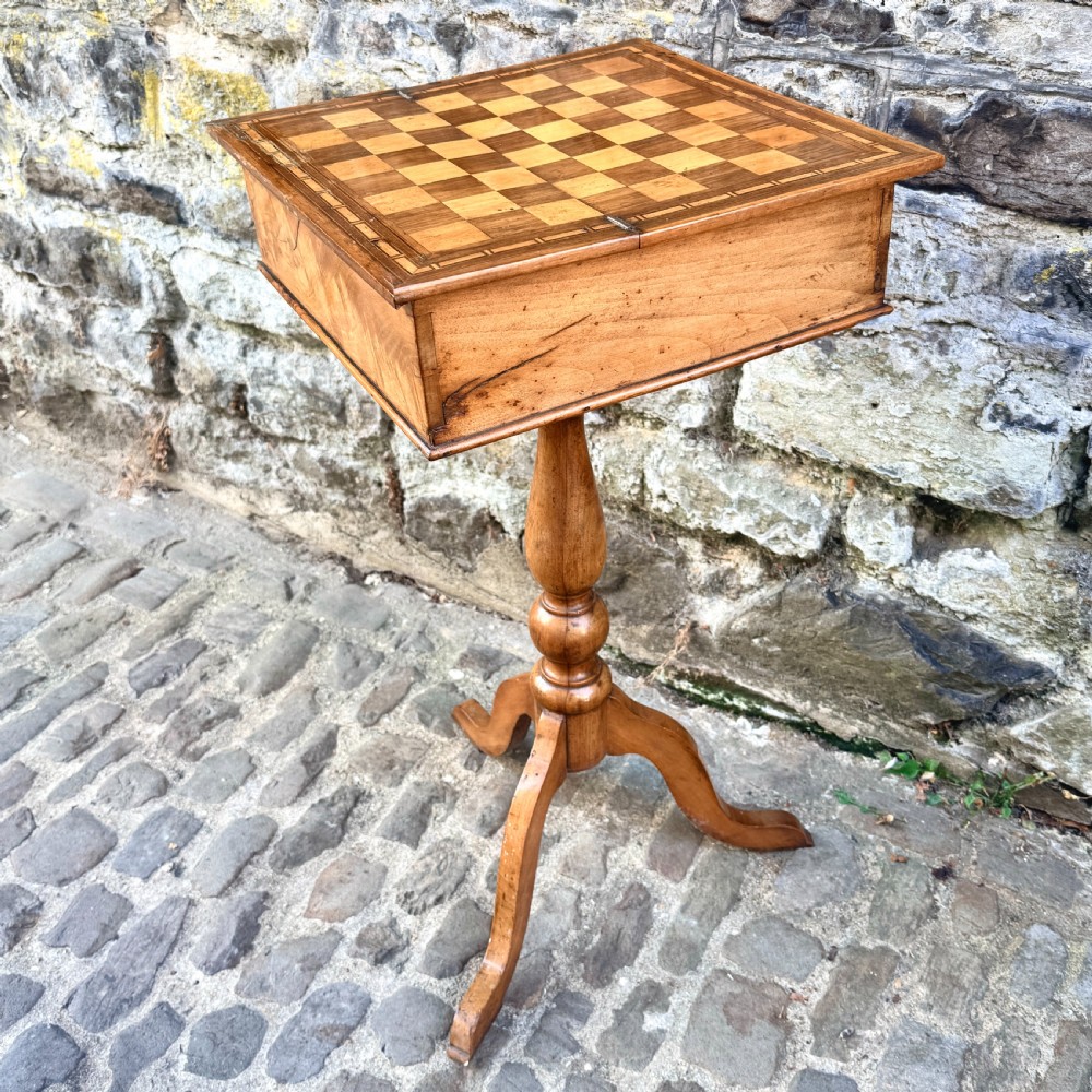 An early nineteenth-century French Provincial wooden chess table featuring an inlaid chessboard top, a turned pedestal support, and a tripod cabriole base. View IX