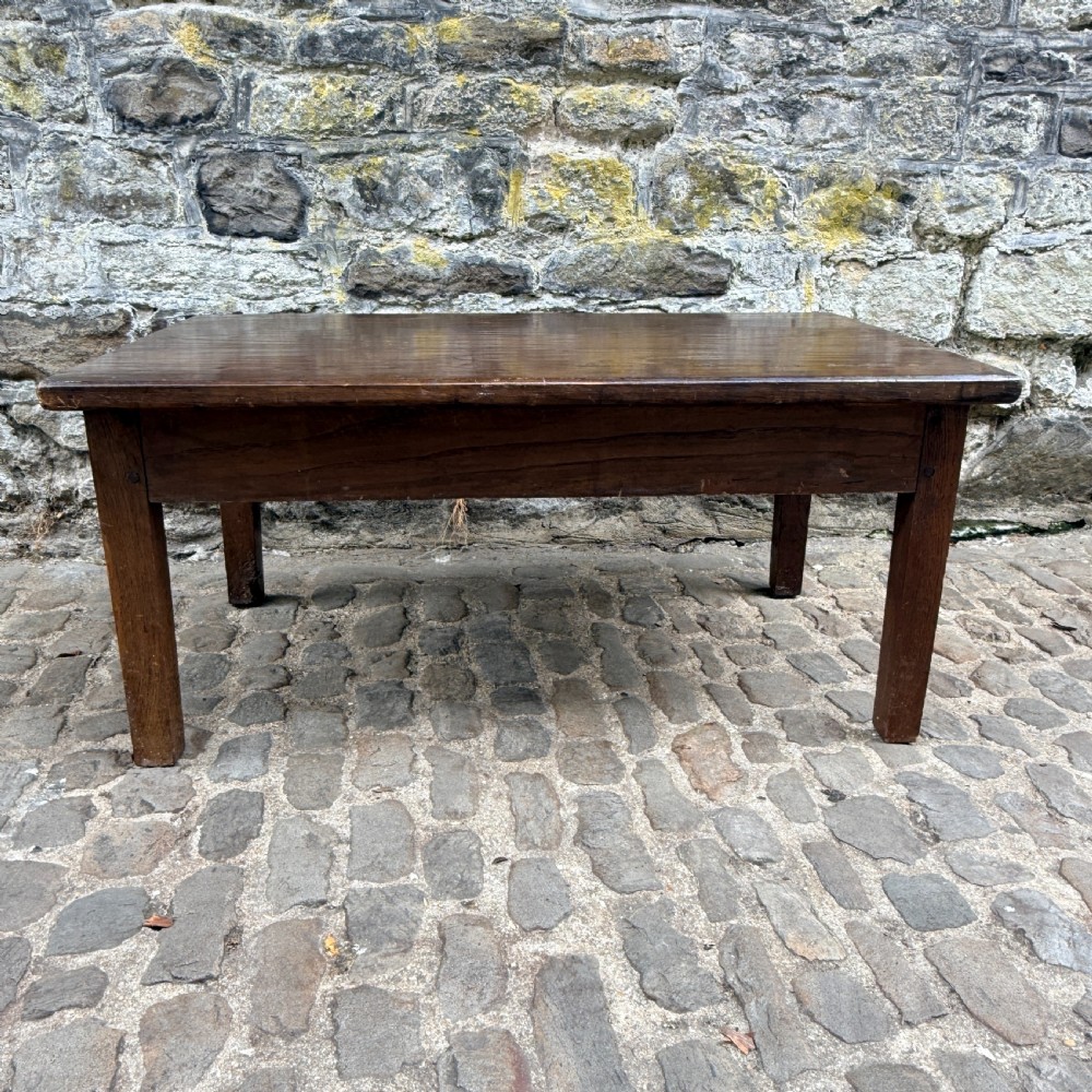 A low rectangular antique coffee table constructed from dark oak and chestnut, featuring a single frieze drawer and four straight square legs. View VI