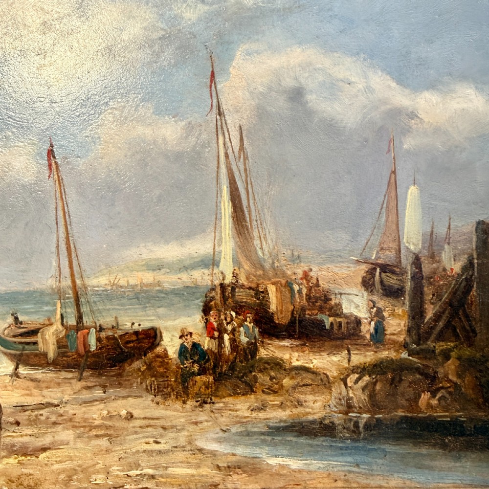 A nineteenth-century coastal oil painting depicting figures and fishing boats on a sandy shore under a cloudy sky, presented in a moulded gold frame. View III