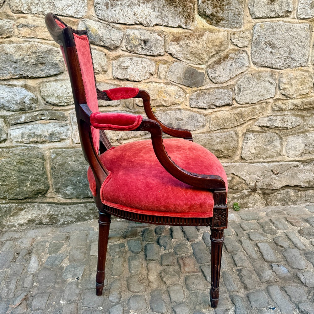 A Sheraton Revival mahogany desk chair with red velvet upholstery, a shield back, and fluted front legs. View V