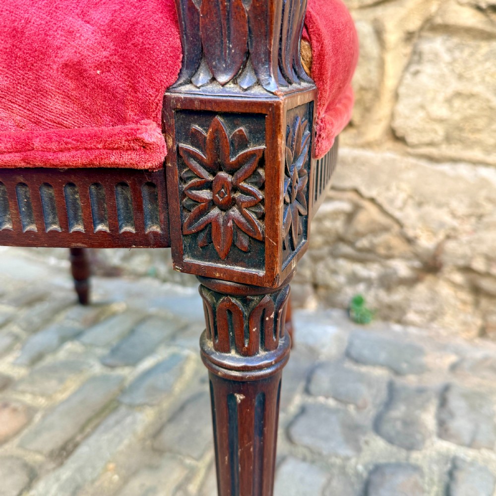A Sheraton Revival mahogany desk chair with red velvet upholstery, a shield back, and fluted front legs. View VII