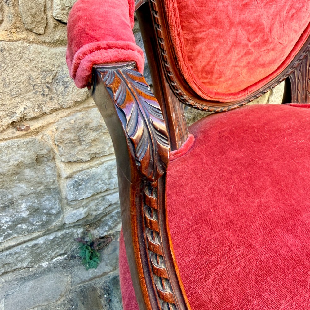 A Sheraton Revival mahogany desk chair with red velvet upholstery, a shield back, and fluted front legs. View VIII