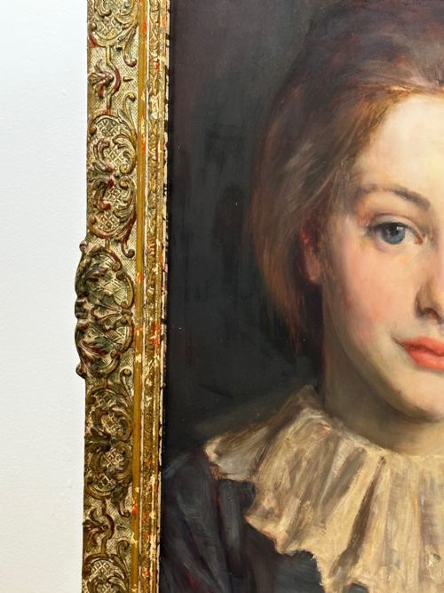 fig 2. A Victorian portrait painting of a young female wearing a ruffled collar and blue dress, presented in an ornate gilded frame.