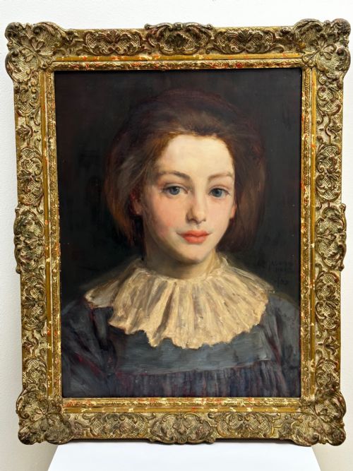 fig 4. A Victorian portrait painting of a young female wearing a ruffled collar and blue dress, presented in an ornate gilded frame.