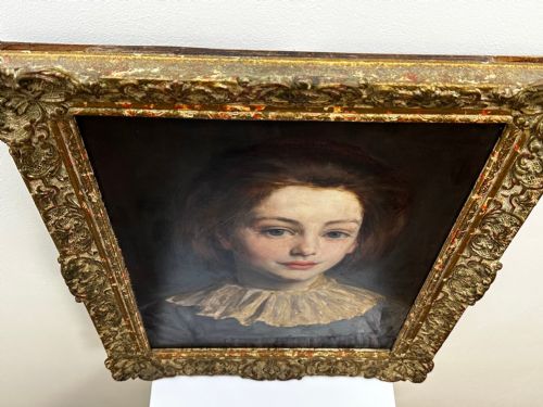 fig 5. A Victorian portrait painting of a young female wearing a ruffled collar and blue dress, presented in an ornate gilded frame.