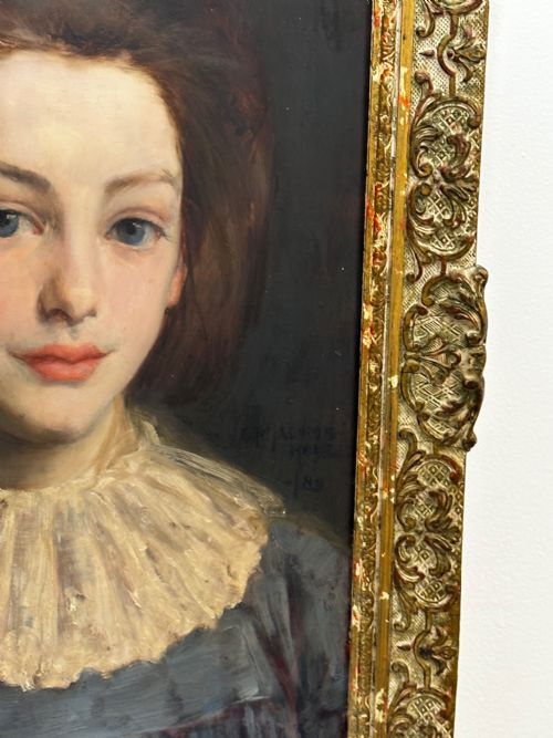 fig 6. A Victorian portrait painting of a young female wearing a ruffled collar and blue dress, presented in an ornate gilded frame.