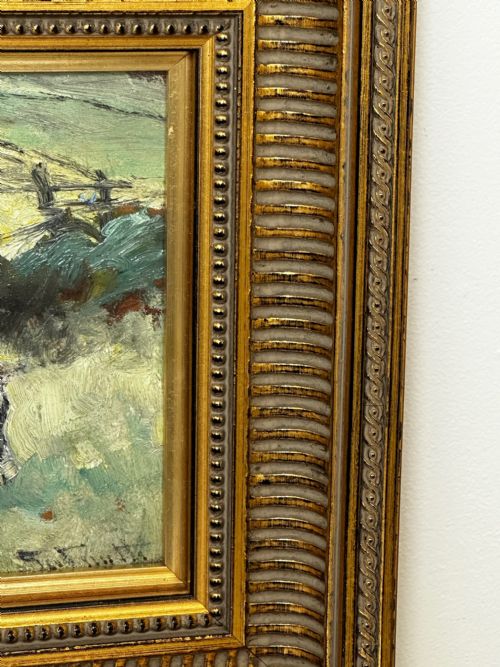 fig 6. An impressionist oil painting depicting a black and white Friesian cow grazing in a field, set within a heavily moulded gilt frame.