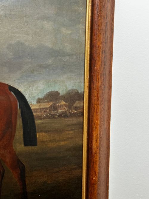fig 3. A 19th-century British oil painting depicting a saddled bay hunter horse and groom standing in a landscape, set within a timber frame.