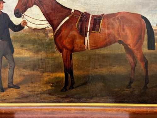 fig 4. A 19th-century British oil painting depicting a saddled bay hunter horse and groom standing in a landscape, set within a timber frame.