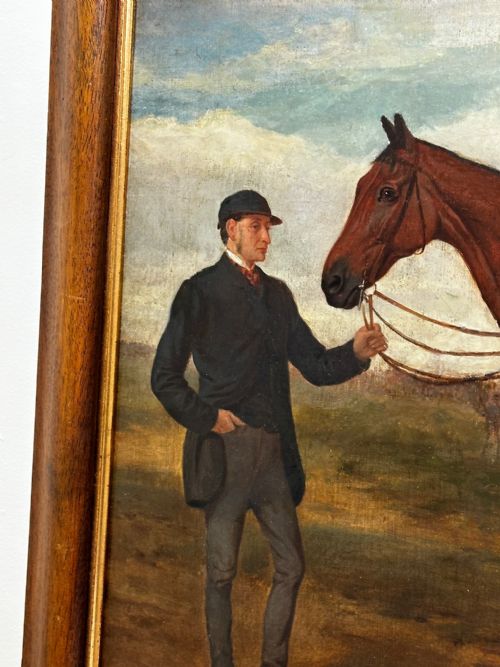 fig 5. A 19th-century British oil painting depicting a saddled bay hunter horse and groom standing in a landscape, set within a timber frame.