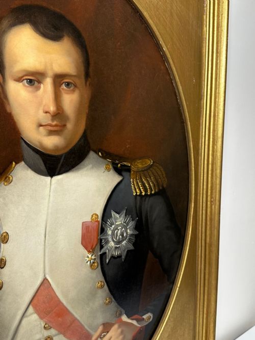 fig 4. A 19th-century French oil painting depicting Napoleon Bonaparte in military uniform with epaulettes, set within an oval spandrel inside a rectangular gilded wood frame.