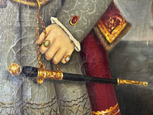 fig 7. A large oil painting in a gilded frame depicting King Henry VIII standing in Tudor costume with jewels, dagger, and feathered cap against a dark backdrop.
