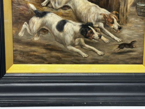 fig 3. A Victorian oil painting framed in ebonised timber and a gilt slip, depicting two white and dark-marked terriers pursuing a rat inside a barn.