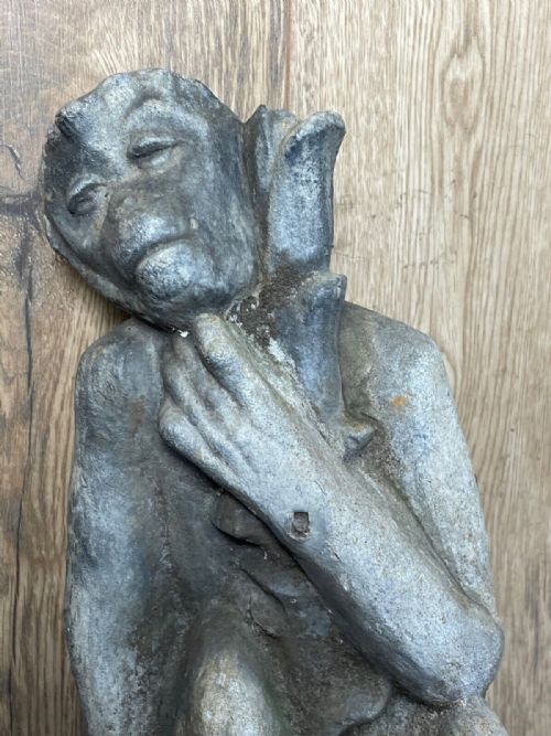 fig 4. A Victorian grey lead sculpture of a contemplative monkey mounted on a cylindrical metal stake.