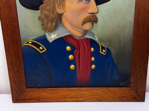 fig 1. A framed oil painting portraying General George Custer in profile wearing a blue uniform with gold stars and a black hat.