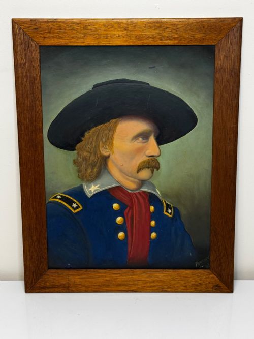 fig 2. A framed oil painting portraying General George Custer in profile wearing a blue uniform with gold stars and a black hat.