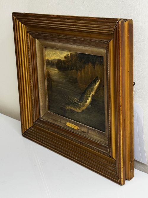fig 2. An antique Victorian oil painting depicting a northern pike fish surfacing from a river, set within a gilded moulded frame.