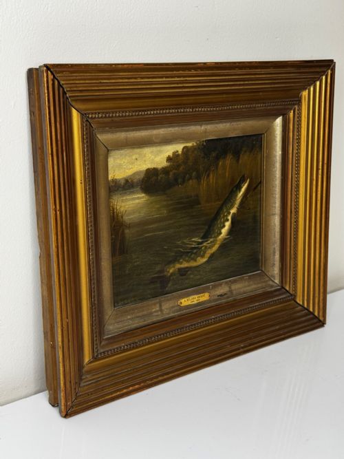 fig 4. An antique Victorian oil painting depicting a northern pike fish surfacing from a river, set within a gilded moulded frame.