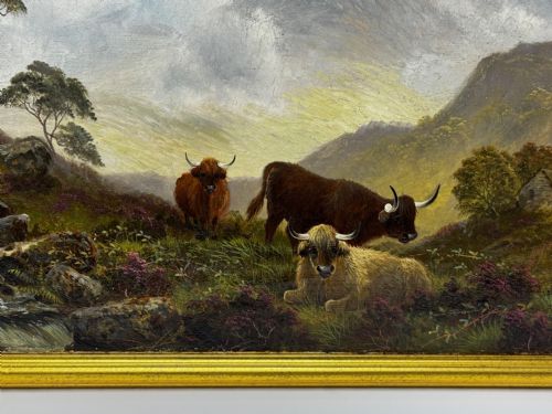 fig 1. A Victorian oil painting depicting three Highland cattle resting on a hillside in a misty Scottish mountain landscape, enclosed in a rectangular gilt frame.