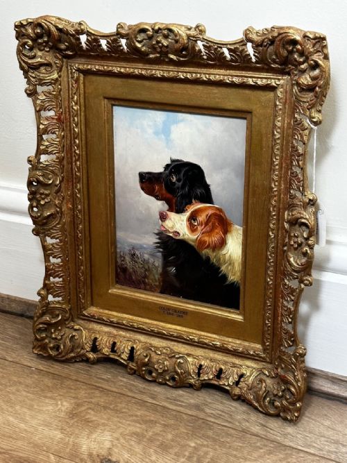 fig 7. An antique Victorian oil painting depicting two setters against a cloudy sky, presented in a carved gold gilt frame.