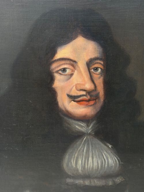 fig 1. A 19th-century framed oil portrait depicting King Charles II wearing armour, a white lace cravat, and the Order of the Garter medallion against a dark background.