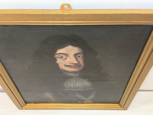 fig 3. A 19th-century framed oil portrait depicting King Charles II wearing armour, a white lace cravat, and the Order of the Garter medallion against a dark background.