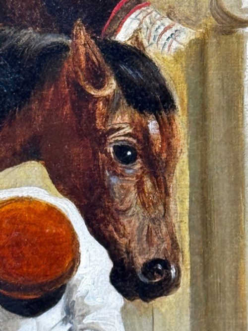 fig 2. A horizontal oil painting depicting grooms tending to horses inside a stable block, housed within a fluted gilt wood frame.