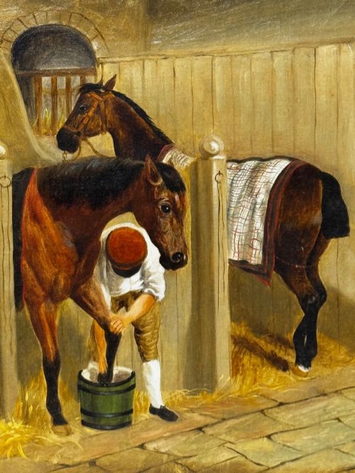 fig 3. A horizontal oil painting depicting grooms tending to horses inside a stable block, housed within a fluted gilt wood frame.