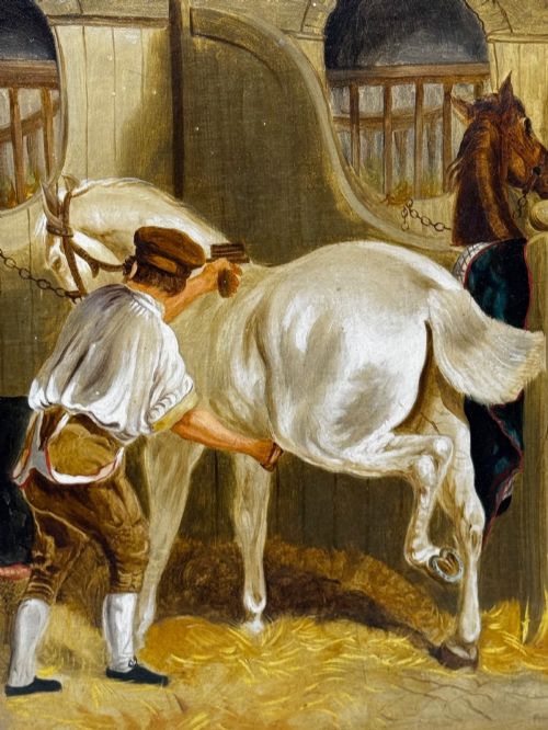 fig 6. A horizontal oil painting depicting grooms tending to horses inside a stable block, housed within a fluted gilt wood frame.