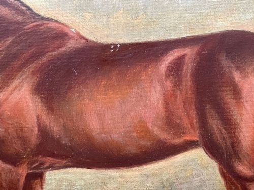 fig 3. A framed oil painting depicting a bay racehorse standing in a stable yard, housed in a moulded dark wood and gilt frame.