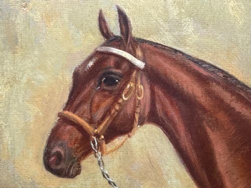 fig 8. A framed oil painting depicting a bay racehorse standing in a stable yard, housed in a moulded dark wood and gilt frame.