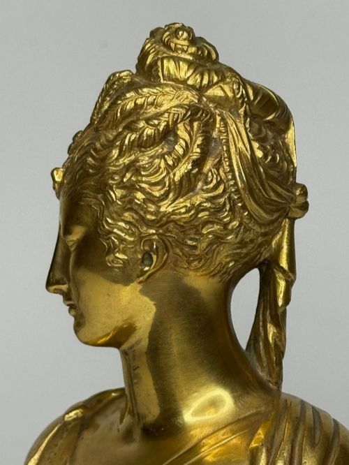 fig 6. A 19th-century gilt bronze bust portrait of Diana de Poitiers featuring an ornate hairstyle and classical drapery, mounted on a dark socle and square variegated marble base.