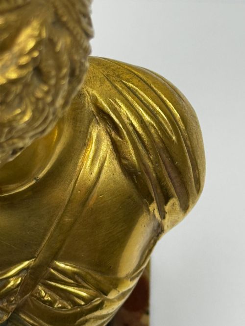 fig 7. A 19th-century gilt bronze bust portrait of Diana de Poitiers featuring an ornate hairstyle and classical drapery, mounted on a dark socle and square variegated marble base.