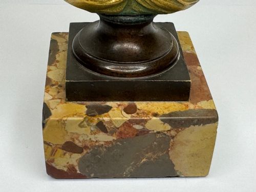 fig 9. A 19th-century gilt bronze bust portrait of Diana de Poitiers featuring an ornate hairstyle and classical drapery, mounted on a dark socle and square variegated marble base.