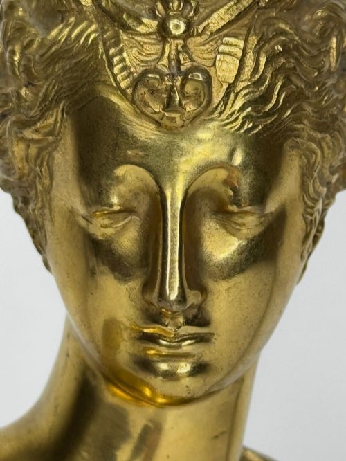 fig 10. A 19th-century gilt bronze bust portrait of Diana de Poitiers featuring an ornate hairstyle and classical drapery, mounted on a dark socle and square variegated marble base.