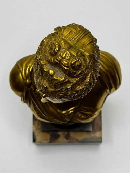 fig 12. A 19th-century gilt bronze bust portrait of Diana de Poitiers featuring an ornate hairstyle and classical drapery, mounted on a dark socle and square variegated marble base.