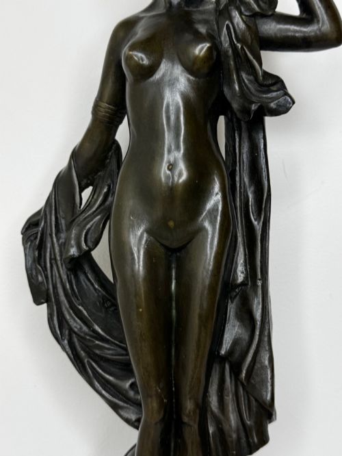 fig 5. A dark brown patinated French bronze sculpture depicting a standing female nude draped in flowing fabric, mounted on a dark marble base.