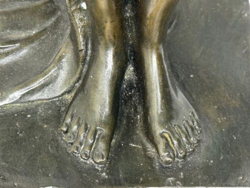 fig 8. A dark brown patinated French bronze sculpture depicting a standing female nude draped in flowing fabric, mounted on a dark marble base.
